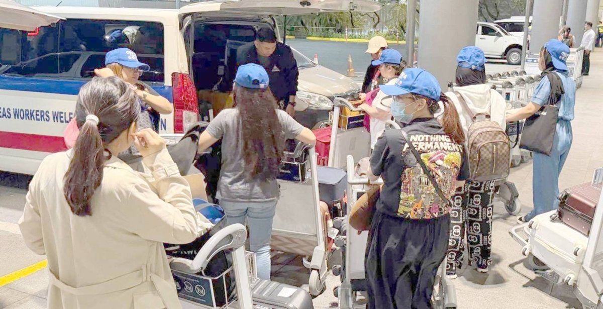 WELCOME HOME Overseas Filipino workers (OFWs) from Kuwait load their luggage at a transportation van of the Overseas Workers Welfare Administration on May 22, 2026. They are part of the 61 OFWs who were repatriated by the Dep artment of Migrant Workers from Kuwait and Bahrain, amid the ongoing war in the Middle East. PHOTO FROM THE DEPARTMENT OF MIGRANT WORKERS